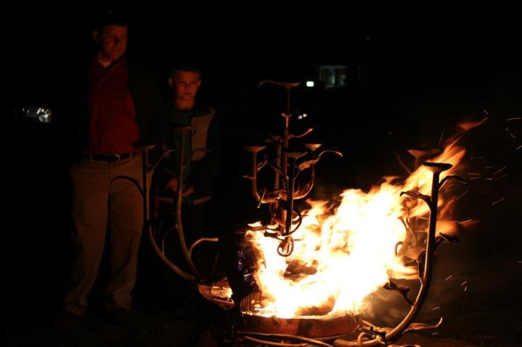 Joe Fister and son Gunnar ignite the new fire  in the Burning Bush sculpture of Saint Andrew's  at the Easter Vigil of 2013.